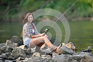 Stunning young woman fishing