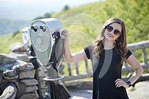 Stunning young woman poses for photo on scenic overlook