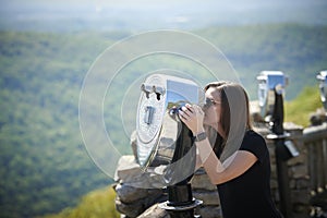 Stunning young woman poses for photo on scenic overlook