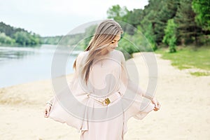 Stunning young woman in white dress outdoor