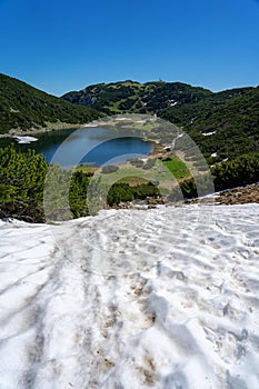 Stunning zireiner see lake in tyrol alm mountains Austria sunny summer weather with snow