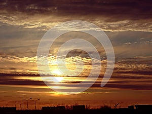 Stunningly beautiful Golden sunset over the town Nadym. The cloudy sky.