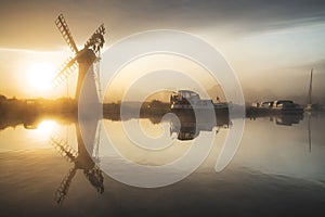 Stunnnig landscape of windmill and calm river at sunrise on Summ