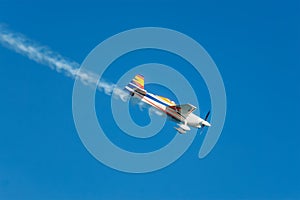 Stunt aerobatic plane performing stunts in air photo