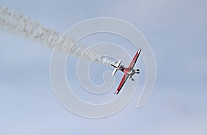 Stunt plane diving with smoke trail.