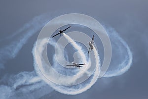 Stunt planes, weaving about with white smoke
