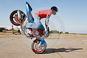 Stunt rider making stoppie