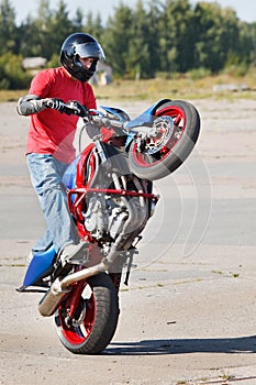 Stunt rider making wheelie