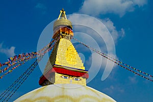 Stupa with Buddha eyes and Tibetan prayer flags in Nepal