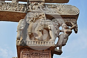 Stupa No 1, East Gateway. Pillar capitals are supported by four elephants. Carved damsels or Shalabhanjikas are seen clinging to t