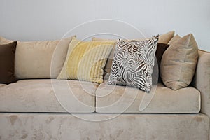 Sturdy brown tweed sofa with grey patterned pillows