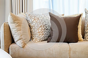 Sturdy brown tweed sofa with grey patterned pillows