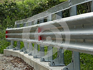 STURDY STEEL GUARDRAIL, ANCHORED TO A CONCRETE BASE