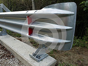 STURDY STEEL GUARDRAIL, ANCHORED TO A CONCRETE BASE