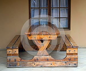 Sturdy wooden table with two seats attached