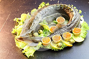 Sturgeon with red caviar and lettuce