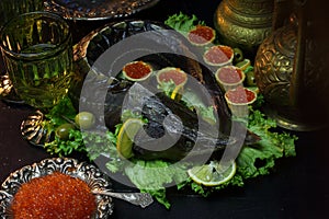 Sturgeon with red caviar and lettuce