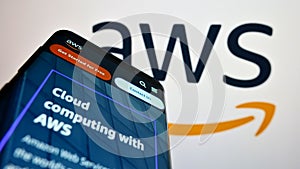Smartphone with webpage of US cloud company Amazon Web Services Inc. (AWS) on screen in front of logo.
