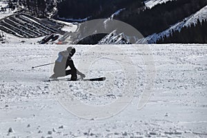 Style carving. A male skier training on competition in downhill. Carve position. Black and blue jacket. Chopok, Low Tatras,