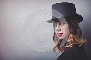 Style and mystique redhead girl in top hat