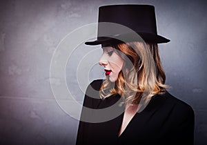 Style and mystique redhead girl in top hat