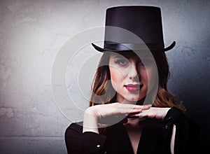 Style and mystique redhead girl in top hat