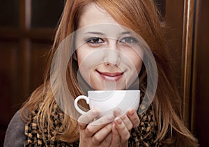 Style redhead girl drinking coffee