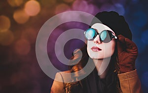 Style redhead woman in sunglasses and coat