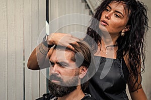 style your hair. brutal bearded man at hairdresser salon. hair wash and care. new stylish haircut.