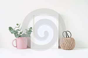 Styled composition with white frame and pink ranunculos
