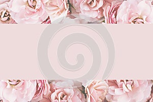 Styled feminine flat lay on pale pastel pink background of roses , top view. Minimal woman`s desktop with blank page mock up, open