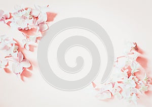 Styled feminine flat lay on pale pastel pink background, top view. Minimal woman`s desktop with blank page mock up, spring lilac