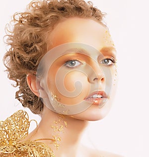 Styled Golden Woman's Face. Curly Hair. Professional Bronzed Makeup