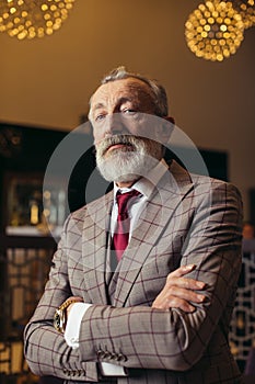 Styled portrait of businessman sitting in armchair at office