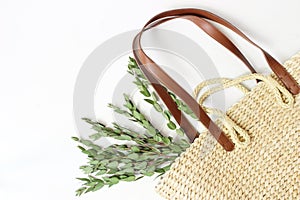 Styled stock photo. Feminine still life composition with straw French basket bag with long leather handles and