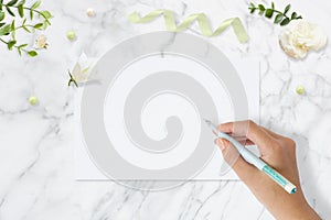 Styled stock photo. Feminine wedding desktop mockup. Greeting card. Flowers, paper, pen, tape on delicate marble