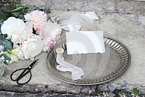 Styled stock photo. Feminine wedding still life composition with vintage silver tray, old scissors and silk ribbons