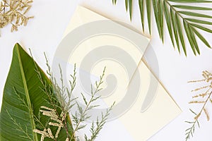 Styled summer wedding desktop stationery mockup. Blank greeting and invitation card. Green tropical leaves with empty
