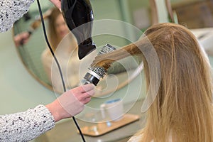 styling hair dryer in beauty salon