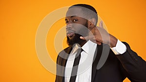 Stylish african-american male in formalwear making call me gesture, dating site