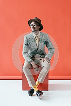 stylish african american man posing in retro hat