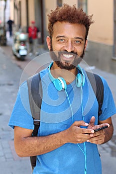 Stylish afro man holding a cell phone