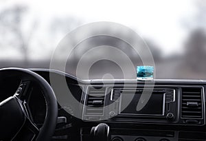 Stylish air freshener on dashboard