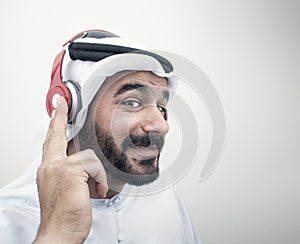 Stylish Arabian man in headphones, Arabian guy listening to music.. photo