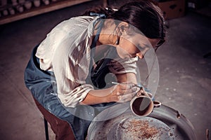 Stylish artisan master working with pottery at the ceramic workshop. Craft production.