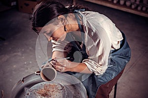 Stylish artisan master working with pottery at the ceramic workshop. Craft production.