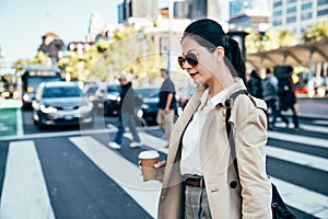 Stylish asian woman walking on crosswalk