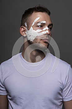 Stylish athletic male artist wearing a white t-shirt stained wit