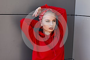 Stylish attractive young woman with beautiful blue eyes with sexy lips with natural make-up with a red bandana