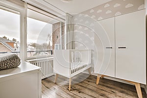Stylish baby bed and a white wooden